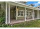 Inviting front porch with brick flooring, classic rocking chairs, and stylish pendant lights at 3450 Whitner Way, Sanford, FL 32773