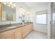 Bathroom featuring double vanity and large mirrors at 398 Pine Tree Rd, Lake Mary, FL 32746
