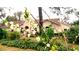 Charming home surrounded by lush landscaping and blooming trees in the yard at 398 Pine Tree Rd, Lake Mary, FL 32746