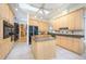 A spacious kitchen with a center island, tile flooring, lots of cabinet space and stainless steel appliances at 398 Pine Tree Rd, Lake Mary, FL 32746
