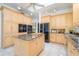 The spacious kitchen features an island with granite countertop, tile floors, and stainless steel appliances at 398 Pine Tree Rd, Lake Mary, FL 32746