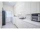 Functional laundry room with ample cabinet space, modern washer/dryer, sink and lots of counter space at 398 Pine Tree Rd, Lake Mary, FL 32746