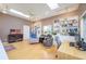 Bright living room with hardwood floors, skylights, built-in bookshelves, and comfortable seating at 398 Pine Tree Rd, Lake Mary, FL 32746