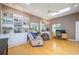 Bright living room with hardwood floors, skylights, built-in bookshelves, and cozy seating at 398 Pine Tree Rd, Lake Mary, FL 32746