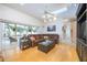 Bright living room with skylights, wood floors, and large sliding glass doors to the pool area at 398 Pine Tree Rd, Lake Mary, FL 32746