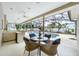 Covered patio with outdoor dining area overlooking the serene screened-in pool at 398 Pine Tree Rd, Lake Mary, FL 32746