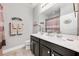 Well-lit bathroom with a dark wood double vanity, framed mirror, and decorative accents at 4160 Golden Willow Cir, Apopka, FL 32712