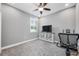 Flex bedroom featuring a tv, stationary bike, and window with plantation shutters at 4160 Golden Willow Cir, Apopka, FL 32712