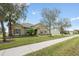 Charming single-story home with well-manicured lawn, mature trees, and inviting curb appeal at 4160 Golden Willow Cir, Apopka, FL 32712
