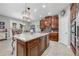 Spacious kitchen with dark wood cabinets, granite countertops, and stainless steel appliances at 4160 Golden Willow Cir, Apopka, FL 32712