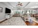 Open-concept living room with hardwood floors, tray ceiling, and lots of natural light at 4160 Golden Willow Cir, Apopka, FL 32712