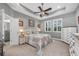Serene main bedroom with a tray ceiling, neutral walls, and ensuite bathroom at 4160 Golden Willow Cir, Apopka, FL 32712