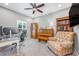Cozy home office with a piano, built in bookcase, desk, and comfortable arm chair at 4160 Golden Willow Cir, Apopka, FL 32712
