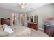 Relaxing bedroom featuring carpet, ceiling fan, dresser, and bright windows at 428 White Cotton Cir, Oviedo, FL 32765