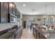 Well-lit kitchen with dark cabinetry, stainless steel appliances, and an open concept layout at 428 White Cotton Cir, Oviedo, FL 32765