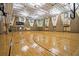 Indoor community basketball court with polished wood floors, multiple hoops, scoreboard, and ample lighting at 5016 Park Central Dr # 2231, Orlando, FL 32839