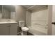 A modern bathroom featuring a vanity sink, toilet, and shower-tub combination inside a condo for sale at 5016 Park Central Dr # 2231, Orlando, FL 32839