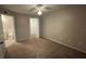 A carpeted bedroom with a ceiling fan and walk-in closet inside a condo for sale at 5016 Park Central Dr # 2231, Orlando, FL 32839