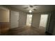 A carpeted bedroom has a view of the bathroom and walk-in closet inside a condo for sale at 5016 Park Central Dr # 2231, Orlando, FL 32839