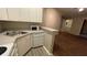 Efficient kitchen with white cabinets, laminate countertops, stainless sink, and newer white appliances at 5016 Park Central Dr # 2231, Orlando, FL 32839