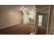 An open living room and kitchen space with wall-to-wall carpet and a ceiling fan in a condo for sale at 5016 Park Central Dr # 2231, Orlando, FL 32839