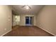 Spacious living room featuring neutral paint, ceiling fan, carpeted floors, and access to the outdoor balcony at 5016 Park Central Dr # 2231, Orlando, FL 32839