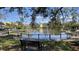 Scenic view of community pond with fountain, gazebo, and seating area surrounded by lush landscaping and palm trees at 5016 Park Central Dr # 2231, Orlando, FL 32839