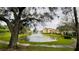 Scenic view of a community pond with a fountain, green grass and buildings in the background creating a tranquil setting at 5016 Park Central Dr # 2231, Orlando, FL 32839