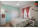 Charming bedroom with light walls, bright floral bedding, and a white metal frame bed at 514 Royal Palm Dr, Kissimmee, FL 34743