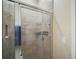 Modern tiled shower with sleek glass doors and built-in shelving for storage at 514 Royal Palm Dr, Kissimmee, FL 34743