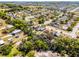 Expansive aerial view of a residential community with lush landscaping, single-Gathering homes, and tree-lined streets in a suburban setting at 525 Gentle Breeze Dr, Minneola, FL 34715
