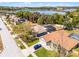 Aerial view of a home, showcasing a garage, driveway, and screened-in backyard pool at 525 Gentle Breeze Dr, Minneola, FL 34715