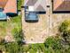 Aerial view shows a spacious backyard with a screened-in pool and room for outdoor activities at 525 Gentle Breeze Dr, Minneola, FL 34715