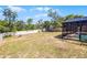 Spacious backyard with fencing and a screened-in pool area with some play equipment at 525 Gentle Breeze Dr, Minneola, FL 34715