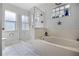 Bright bathroom featuring a glass shower and a soaking tub with tiled walls at 525 Gentle Breeze Dr, Minneola, FL 34715