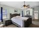 Bright bedroom featuring a wooden bed frame and a ceiling fan with lights at 525 Gentle Breeze Dr, Minneola, FL 34715