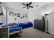 Bedroom featuring two twin beds, gray walls, and a ceiling fan at 525 Gentle Breeze Dr, Minneola, FL 34715