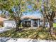 Charming single-story home featuring mature trees and a well-maintained lawn at 525 Gentle Breeze Dr, Minneola, FL 34715