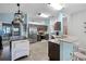 Modern kitchen with stainless steel appliances and an island for food preparation at 525 Gentle Breeze Dr, Minneola, FL 34715