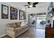 Living room with a comfortable couch and sliding glass doors leading to an outdoor area at 525 Gentle Breeze Dr, Minneola, FL 34715