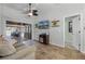Cozy living room with a wall-mounted TV and view of the outdoor living space at 525 Gentle Breeze Dr, Minneola, FL 34715