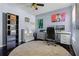 Home office with modern desk and multiple monitors with stylish décor at 525 Gentle Breeze Dr, Minneola, FL 34715