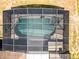 Aerial view shows the screened-in pool with built-in spa surrounded by concrete patio at 525 Gentle Breeze Dr, Minneola, FL 34715