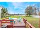 Back deck with beautiful water views, table, chairs and barbeque at 5380 Barton Dr, Orlando, FL 32807