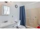 Simple bathroom with white fixtures and a shower-tub combination, offering essential amenities at 5380 Barton Dr, Orlando, FL 32807
