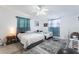 Bright bedroom featuring two beds, a ceiling fan, and light-colored walls with neutral-toned floors at 5380 Barton Dr, Orlando, FL 32807