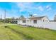 Charming single-story home with white siding, complemented by a lush green lawn and blue skies at 5380 Barton Dr, Orlando, FL 32807