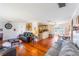 Open-concept living room with polished wood floors, flowing into the dining area and kitchen at 5380 Barton Dr, Orlando, FL 32807