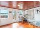 Bright room with hardwood floors and a door leading to the outdoor deck and lake at 5380 Barton Dr, Orlando, FL 32807