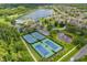 Aerial shot of community featuring a pool, tennis courts, and lake at 5509 Florence Harbor Dr, Orlando, FL 32829